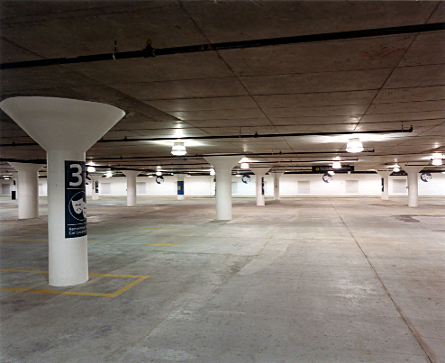 Interior of a parking garage with bright, clean, new-looking surfaces
