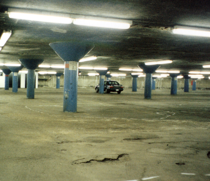 Parking garage interior with damage to floor