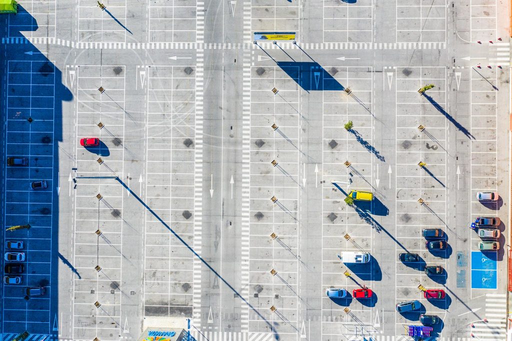 Mostly empty parking lot seen from overhead