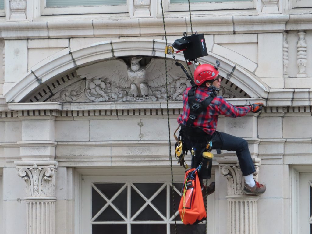 Rope access survey of a building with ornate terra cotta facade