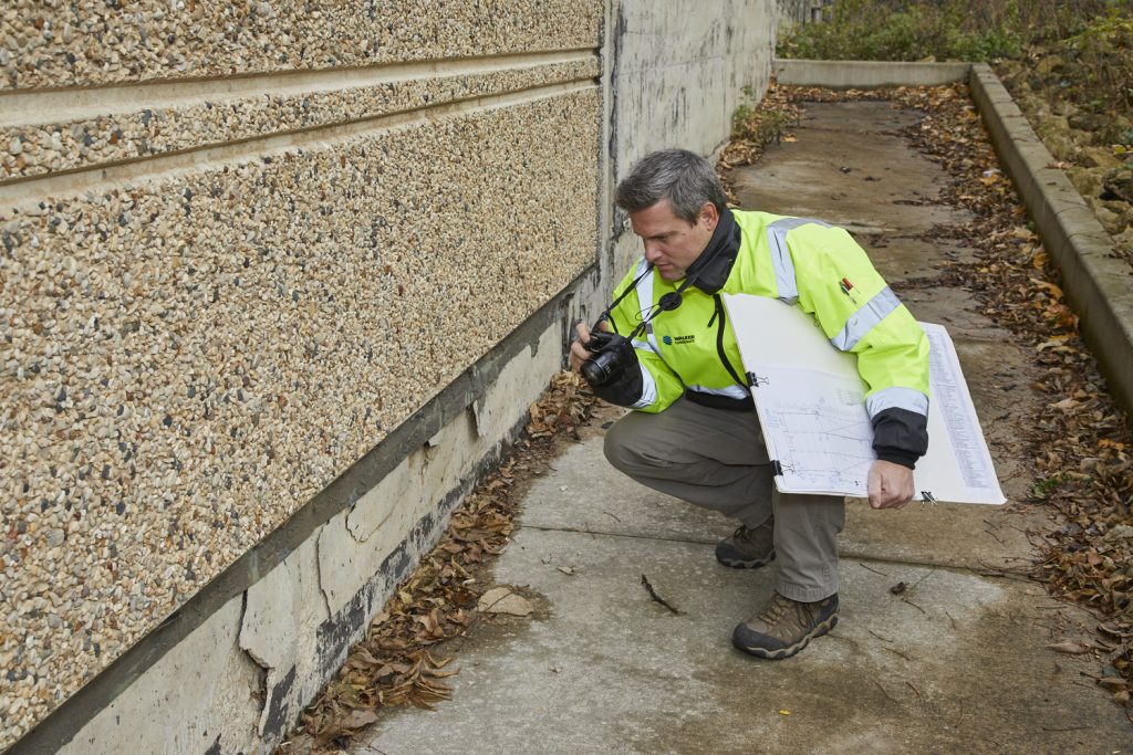 A Walker Consultants expert investigates damage to the exterior of a building