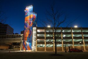 North Grand Ramp seen at night with brightly lit staircase mural and architectural lighting