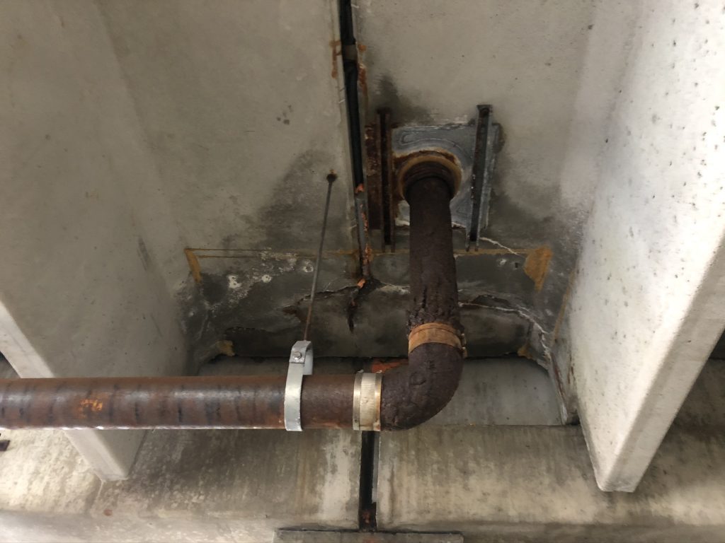 Corroded drainage system inside parking garage