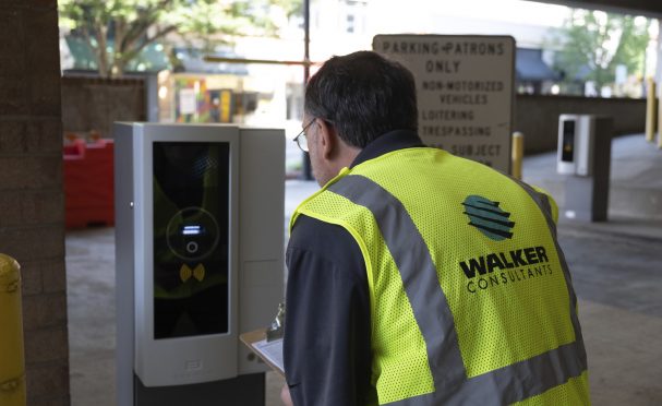 A Walker expert inspects parking access and revenue control equipment after installation