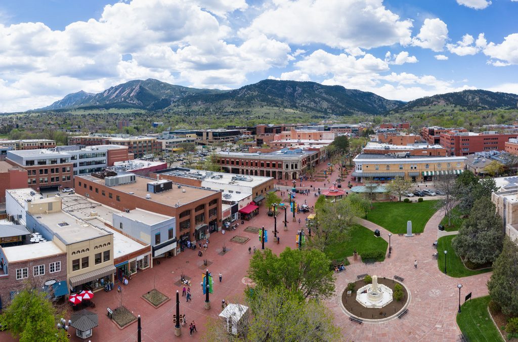 Downtown Boulder seen from above, including a park and street full of pedestrians