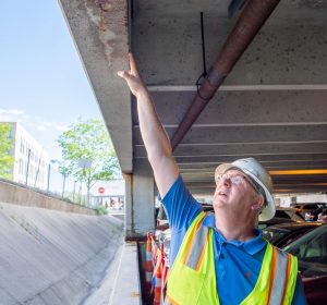 A Walker Consultants engineer performs a condition assessment on a parking structure