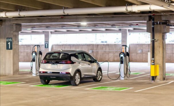 An EV charging inside a parking structure