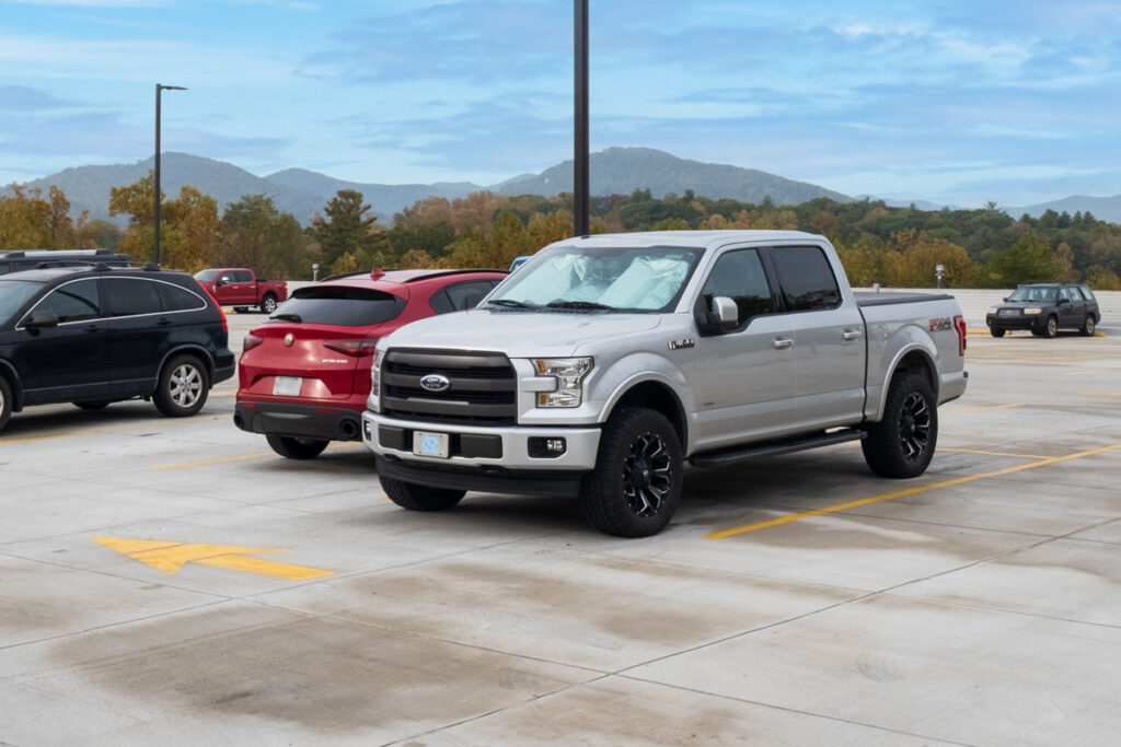 A large pickup truck fills a parking space