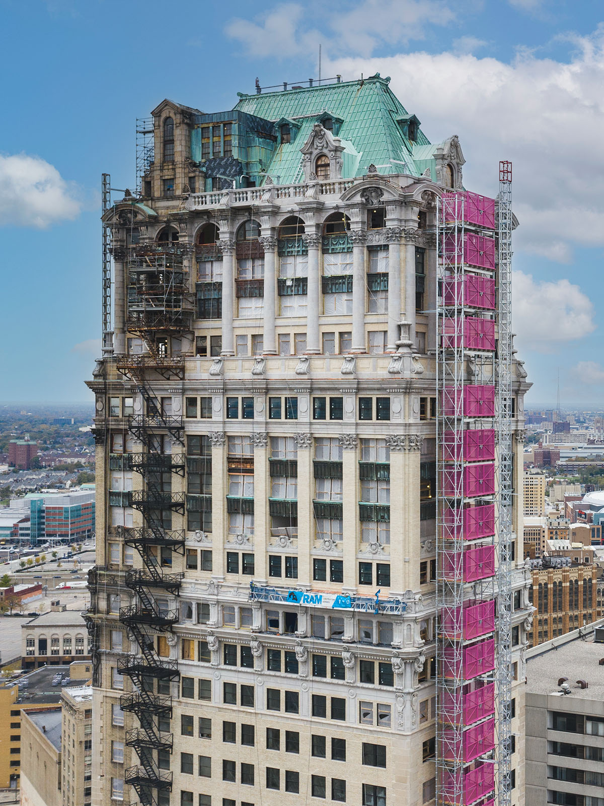 Aerial view of an intricately decorated historic skyscraper under restoration