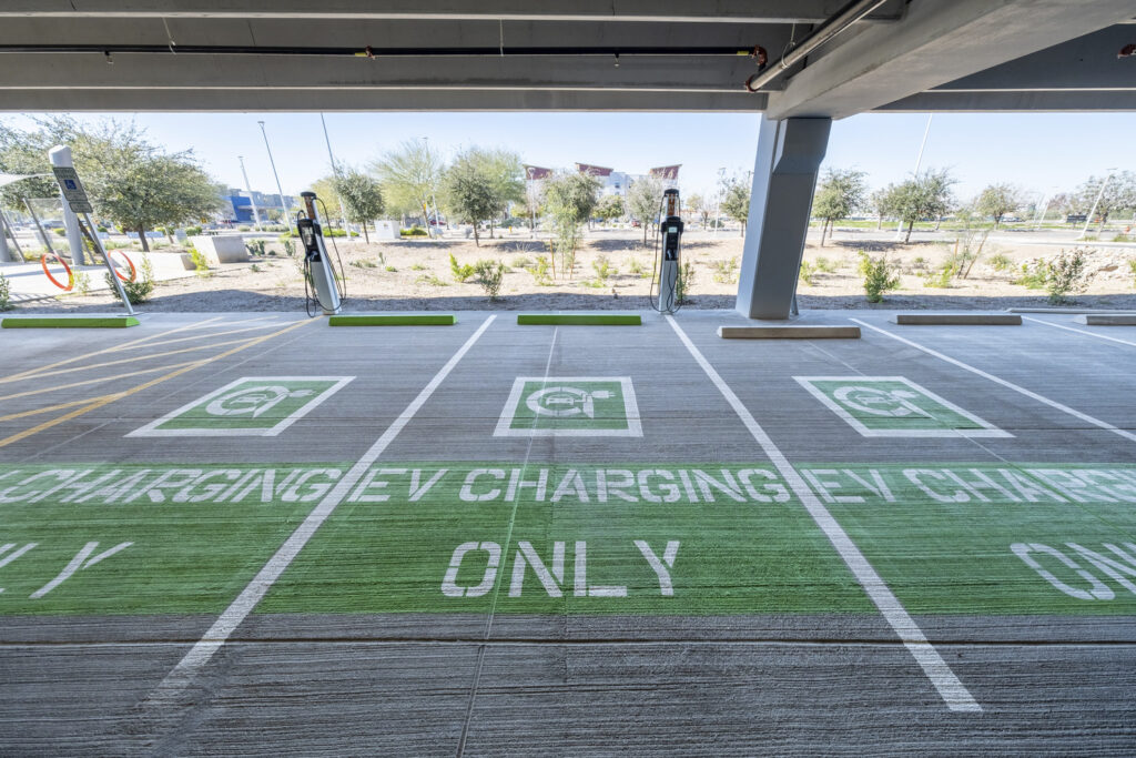 A group of EV charging spaces in a parking structure